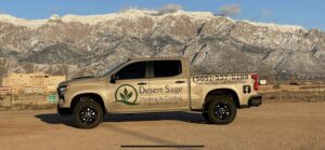 A Desert Sage Heating and Cooling service truck parked with mountains in the background in Albuquerque, NM.