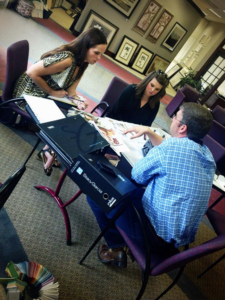 A design consultation with clients reviewing carpet samples at Interior Specialists in Pendleton, IN.