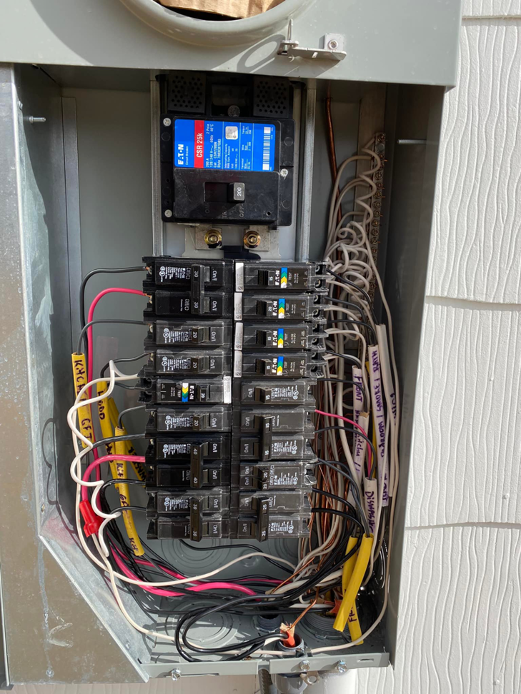Detailed view of organized wiring and circuit breakers inside an open electrical panel by WilPower Electrical Services in Charlotte, NC.