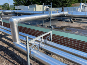 Detailed view of insulated HVAC pipes on a commercial rooftop by North Country Mechanical Insulators in South Burlington, VT.