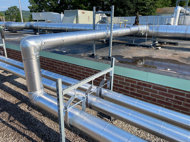 Detailed view of insulated HVAC pipes on a commercial rooftop by North Country Mechanical Insulators in South Burlington, VT.