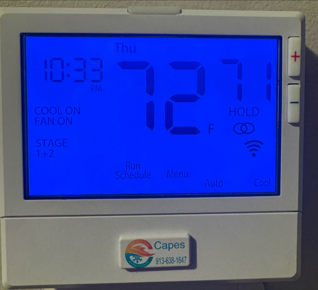 A digital thermostat displaying 72 degrees Fahrenheit with the Capes Whole Homes Heating & Air Conditioning logo in Olathe, KS.