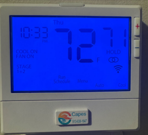 A digital thermostat displaying 72 degrees Fahrenheit with the Capes Whole Homes Heating & Air Conditioning logo in Olathe, KS.