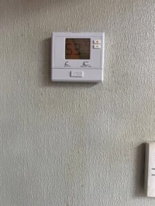 A digital thermostat installed on a wall, showing temperature settings by Spartan Mechanical KC in Spring Hill, KS.