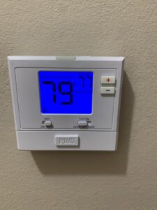 A digital thermostat displaying room temperature and system settings on a wall, installed by Get RiTe A/C & Heating in Madisonville, LA.