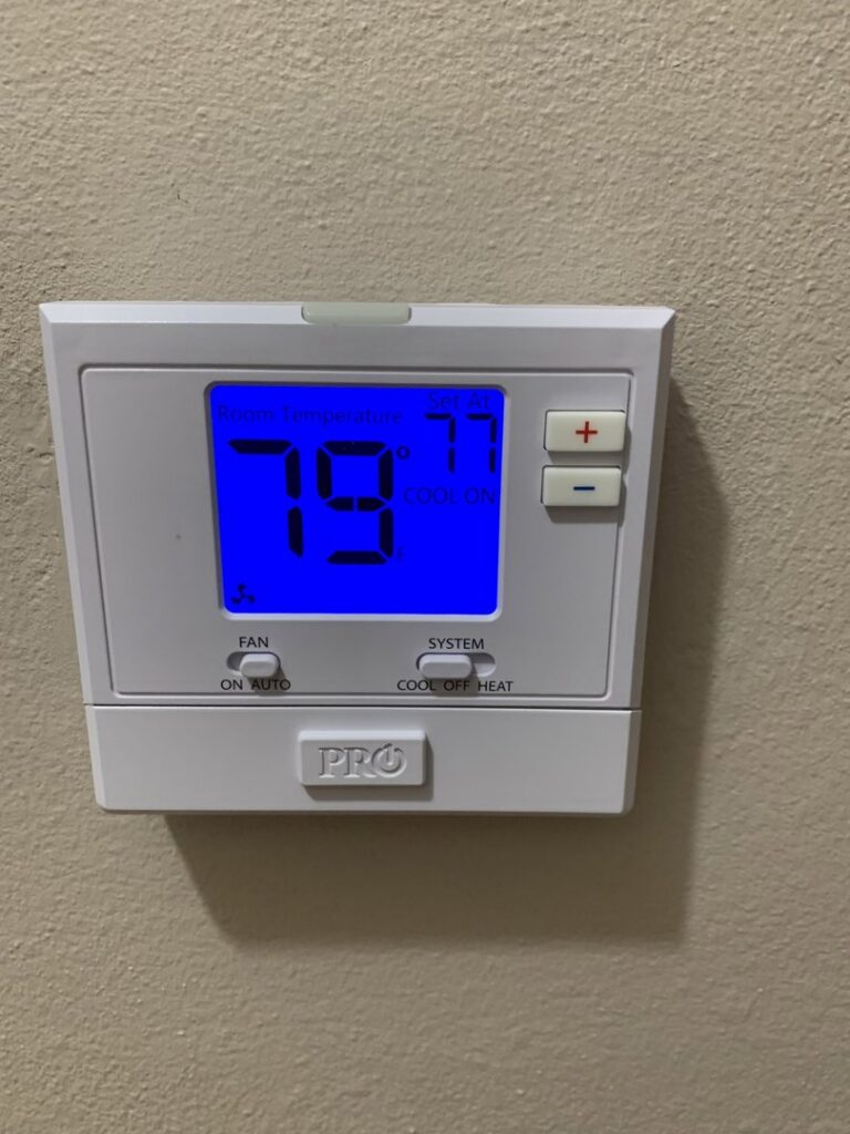 A digital thermostat displaying room temperature and system settings on a wall, installed by Get RiTe A/C & Heating in Madisonville, LA.