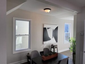 A dining area with a modern flush mount ceiling light installed by Denny Power Solutions in Virginia Beach, VA