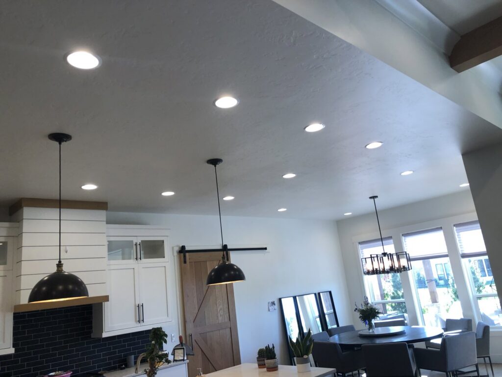 Modern dining area featuring stylish pendant and recessed lighting installed by Veritas Electric in Yalaha, FL.