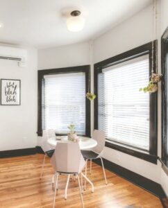 A modern dining area featuring new wood flooring installed by Keystone Carpet & Tile in Omaha, NE.