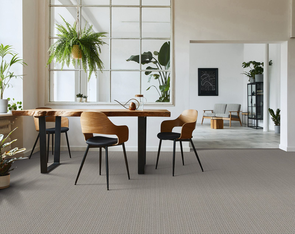 A spacious dining and living room with new light grey carpet installed by AFS Flooring West Jordan, UT