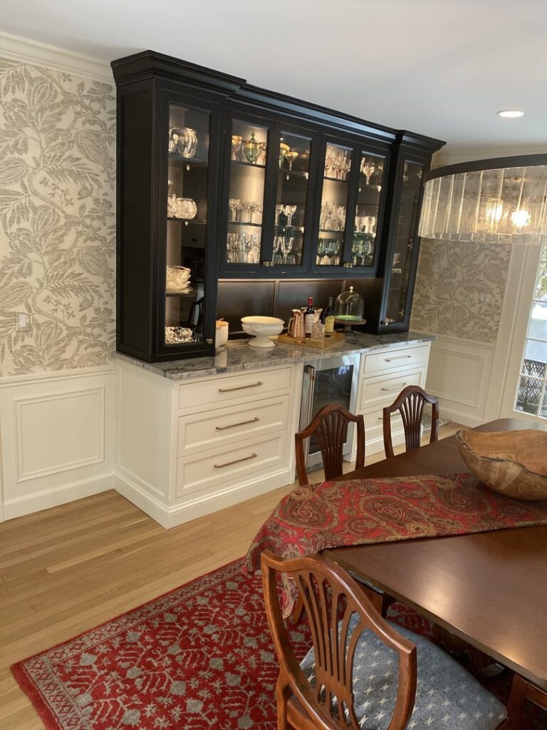 A dining room with a new chandelier and built-in wine fridge installed by EPOS Systems, Inc. in West Springfield, MA.