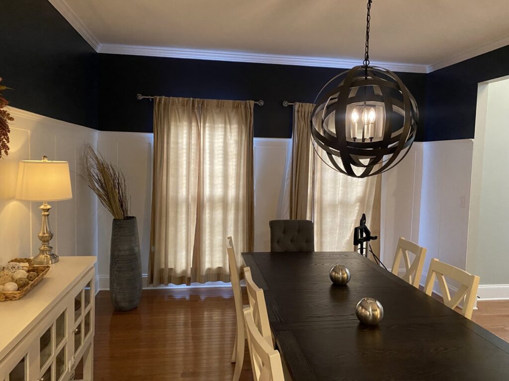 A modern spherical chandelier installed in a dining room by Clarity Handyman Service in Raleigh, NC