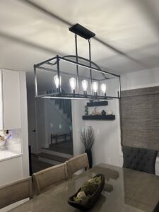 A modern rectangular chandelier installed in a dining room by E & E Electric in Post Falls, ID.