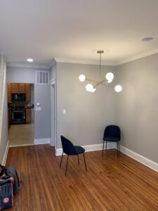 A dining room featuring a modern chandelier installed by Moss Contracting in Philadelphia, PA.