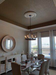 Elegant dining room chandelier installation completed by Powered By Voltron in San Antonio, TX.