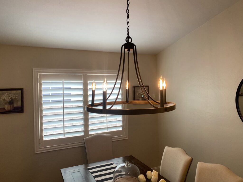 A stylish chandelier installed in a dining room by Pro Solutions Electric in Glendale, AZ.