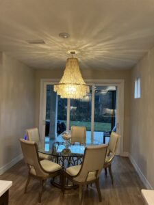 A stunning chandelier illuminating a dining room, installed by T.E.C Electrical Contracting, LLC in Jacksonville, FL