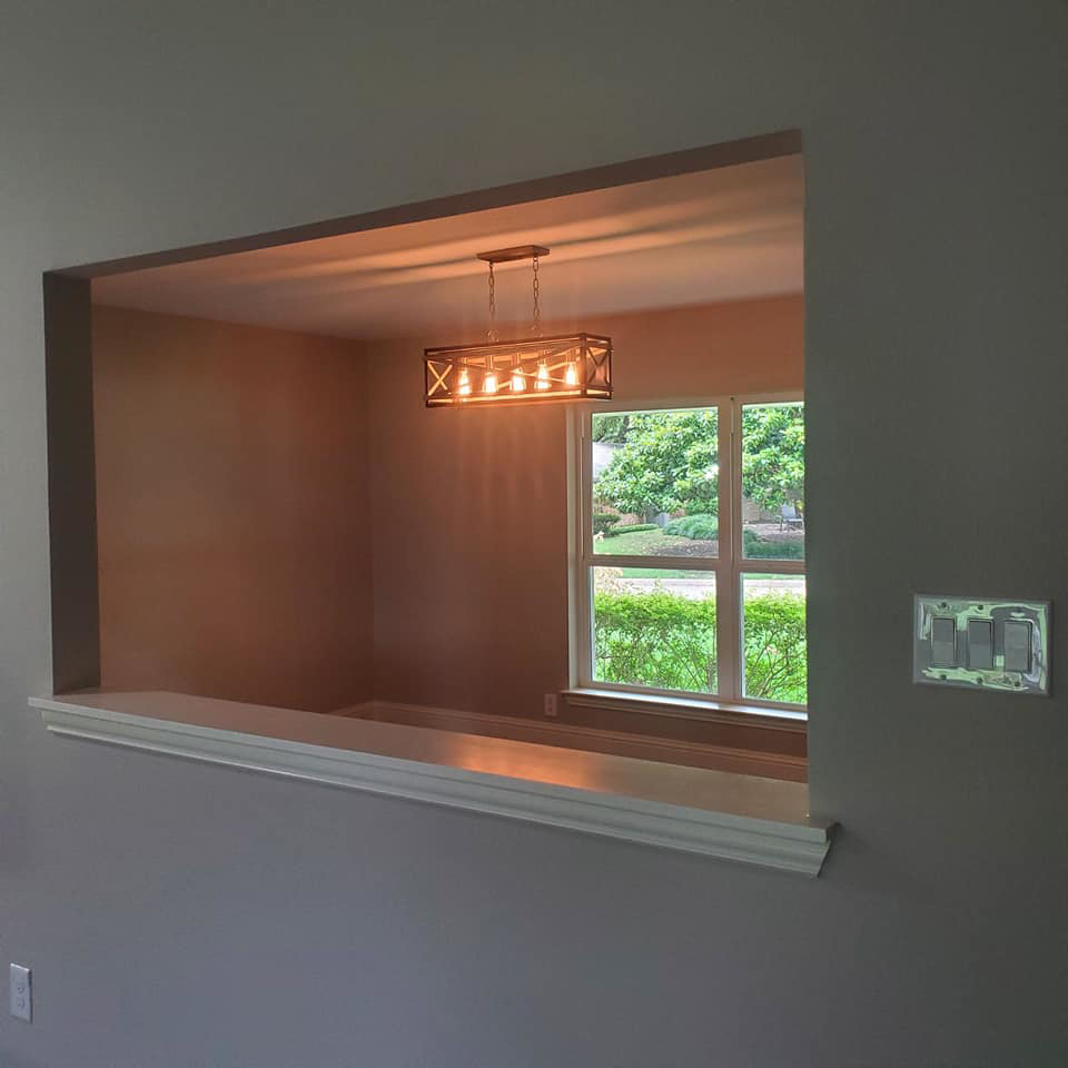 A dining room featuring a stylish chandelier and wall light switches installed by Triple JS & B Electric Inc. in Dallas, TX