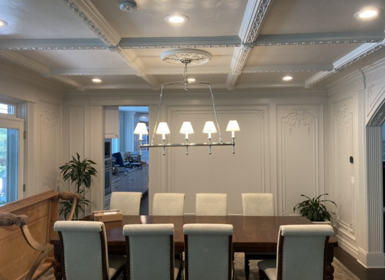 A beautifully lit dining room featuring a chandelier and recessed lighting installed by Skousen Electric LLC in Sandy, UT.