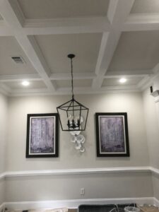 A dining room featuring a modern chandelier and recessed lights installed by McCall Enterprises in Atlanta, GA.