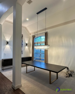 A modern dining room featuring a newly installed chandelier and wall sconces by O Electric Services in Dallas, TX.