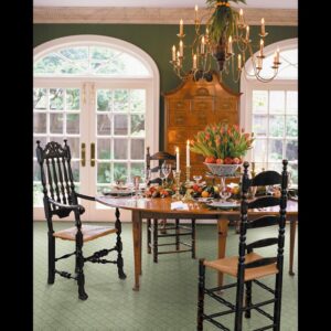 An elegant dining room featuring a green patterned carpet installed by Eatherton's Fashion Floors in St. Louis, MO.