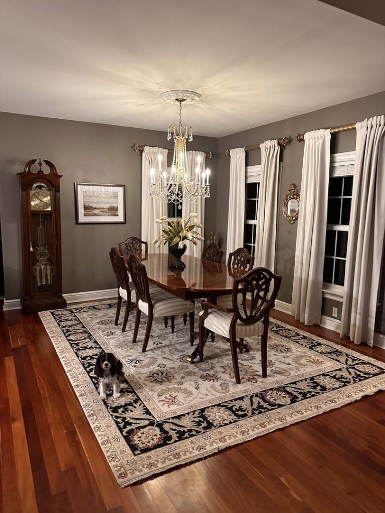 A traditional oriental area rug enhancing a formal dining room by Kaoud Rugs in West Hartford, CT.