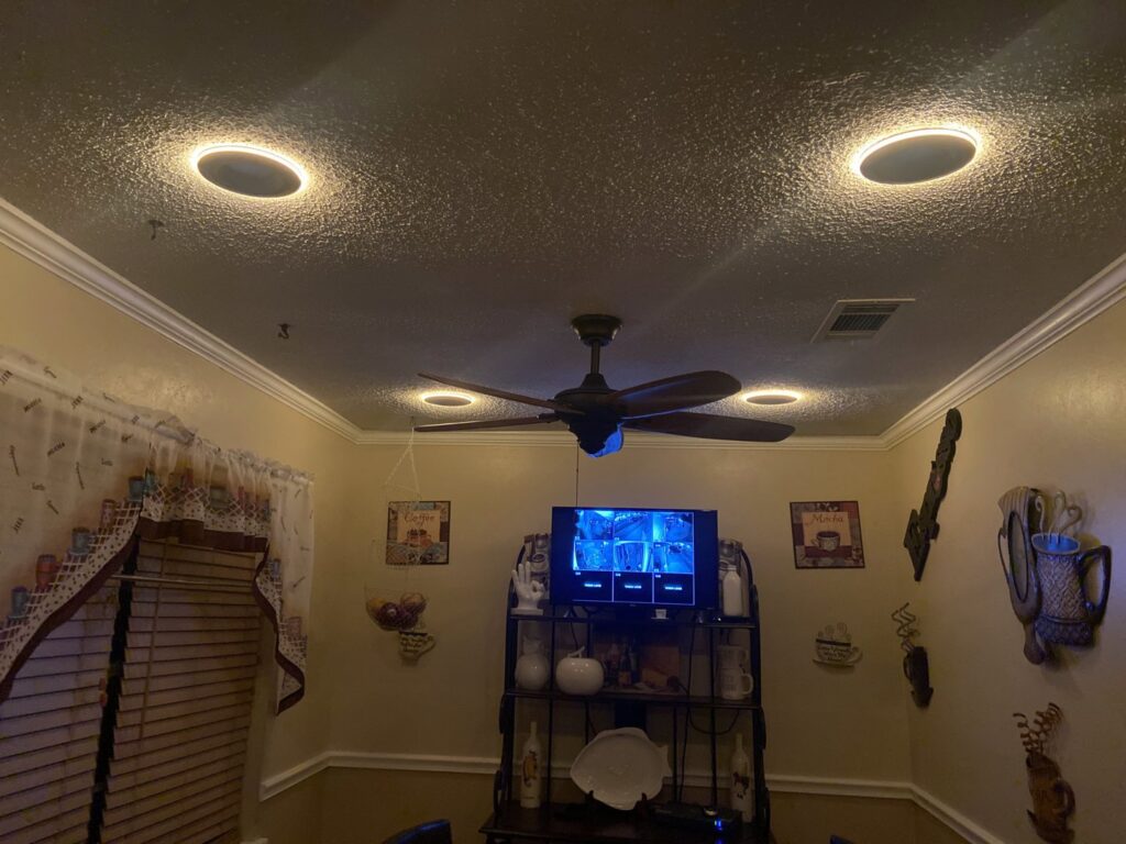 A dining room with new recessed lighting and a ceiling fan installed by Joule Electrical A/C & Heating Services in New Orleans, LA.
