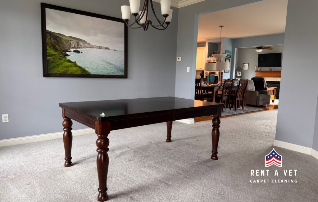 A dining room with a dark wood table on a freshly cleaned carpet by Rent A Vet Carpet Cleaning in St. Charles, MO.