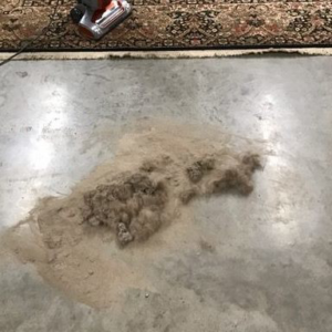 A pile of dirt and debris removed from a rug during a professional cleaning service by All Clean of the Triad in High Point, NC.