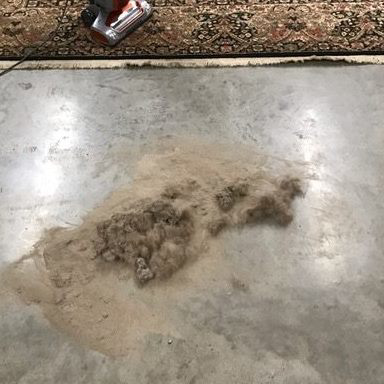A pile of dirt and debris removed from a rug during a professional cleaning service by All Clean of the Triad in High Point, NC.