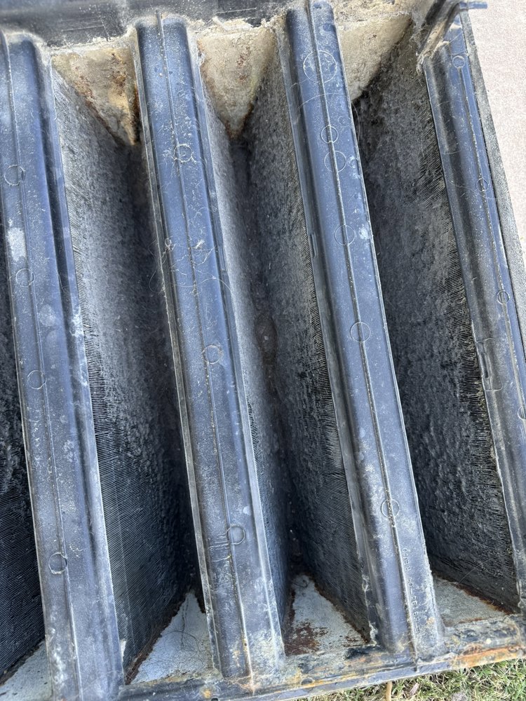 A close-up view of dirty AC coils and fins, indicating a need for cleaning by Desert Heroes HVAC in Phoenix, AZ