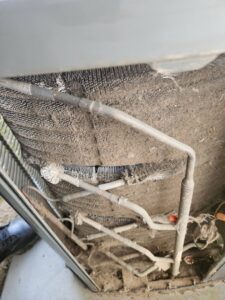 Dirty coils inside an outdoor air conditioning unit, indicating a need for cleaning by All Around Heating & Cooling in Akron, OH.