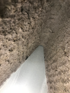An interior view of a dirty air duct being cleaned or sealed by Aeroseal of Peoria in Peoria, IL