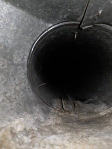 The interior of a dirty air duct showing dust and debris, ready for cleaning by Affordable Quality Air Duct Cleaning in Denver, CO