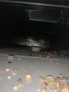 A view inside a very dirty air duct interior before professional cleaning by Air Duct Solutions in Waukee, IA.