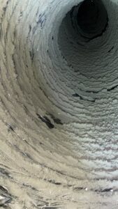 The interior of a very dirty air duct, showing the need for HVAC cleaning services from EZ Comfort Air Conditioning & Heating LLC in Humble, TX.