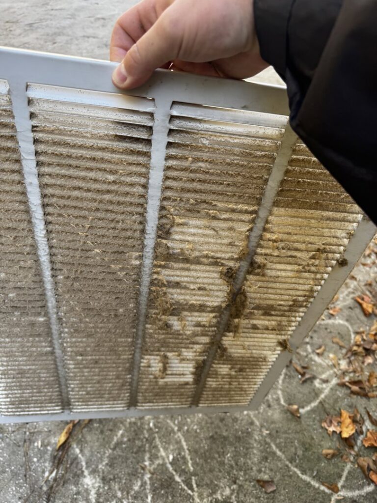 An extremely dirty air return vent and filter, highlighting the need for HVAC maintenance by OnPoint Heating and Air in Commerce City, CO.