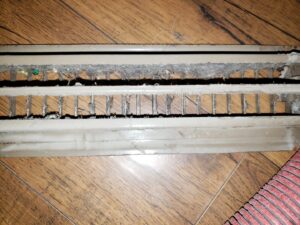 A close-up of a dirty air vent register before cleaning by APEX Clean Air in South Salt Lake, UT.