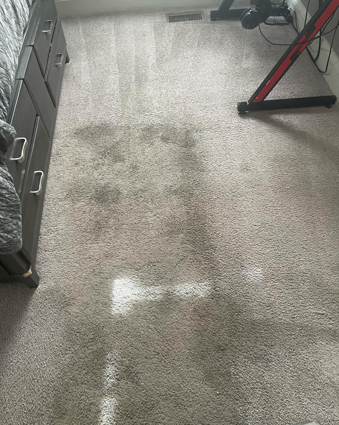 A dirty bedroom carpet with noticeable stains before professional cleaning by D&A Carpet Cleaning in Durham, NC.