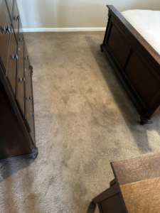 A dirty bedroom carpet showing stains before professional cleaning by J & C Stain Masters in Tallahassee, FL.