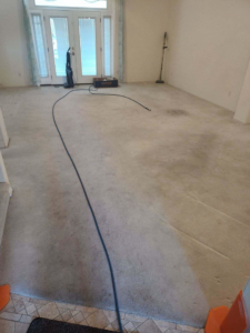 A dirty carpet before professional cleaning with equipment visible, by Coyote Carpet Cleaning LLC in Bunkerville, NV.