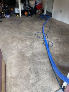 A dirty carpet with cleaning hoses laid out, ready for a professional cleaning service by Koky's Carpet Cleaning in Bakersfield, CA