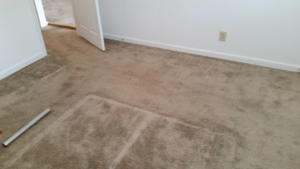 A dirty carpeted room with tools, indicating work in progress or needed service from Magic Wand Services in Wichita, KS