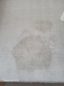 A close-up of a dirty chevron patterned carpet before cleaning by Heaven's Best Carpet Cleaning in San Antonio, TX.