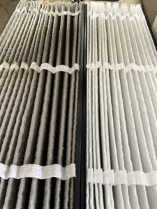 A side-by-side comparison of a dirty air filter next to a clean one, demonstrating air quality service by Supertech Home Services in Warren, MI.
