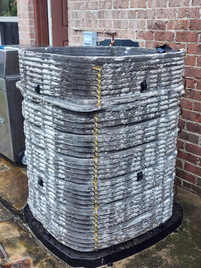 A dirty and clogged outdoor AC coil requiring maintenance or cleaning by Xtreme Heating & Cooling in Tulsa, OK