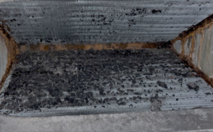A close-up view of a dirty and clogged HVAC coil, indicating a need for cleaning or service by Summit Service Heating and Air in Hilton Head Island, SC.