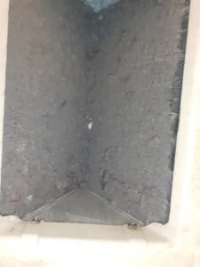 A dirty and clogged HVAC evaporator coil inside a unit, indicating a need for cleaning or service from Arrowseal of Billings HVAC in Billings, MT.