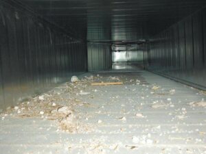 The interior of a large, dirty commercial air duct filled with debris, showing the need for cleaning by Fresh N Clean Duct Cleaning in Arvada, CO.